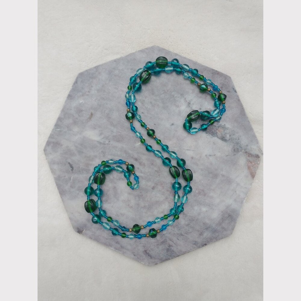 Long necklace of blue, turquoise and green glass beads